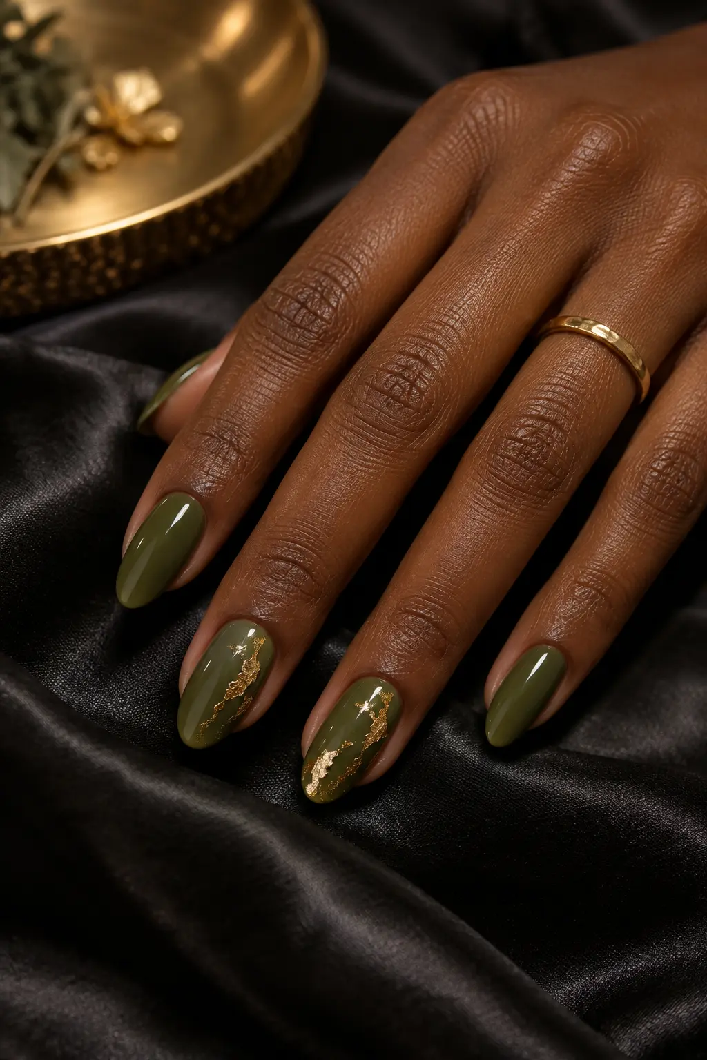 Olive green nails with irregular gold foil accent details