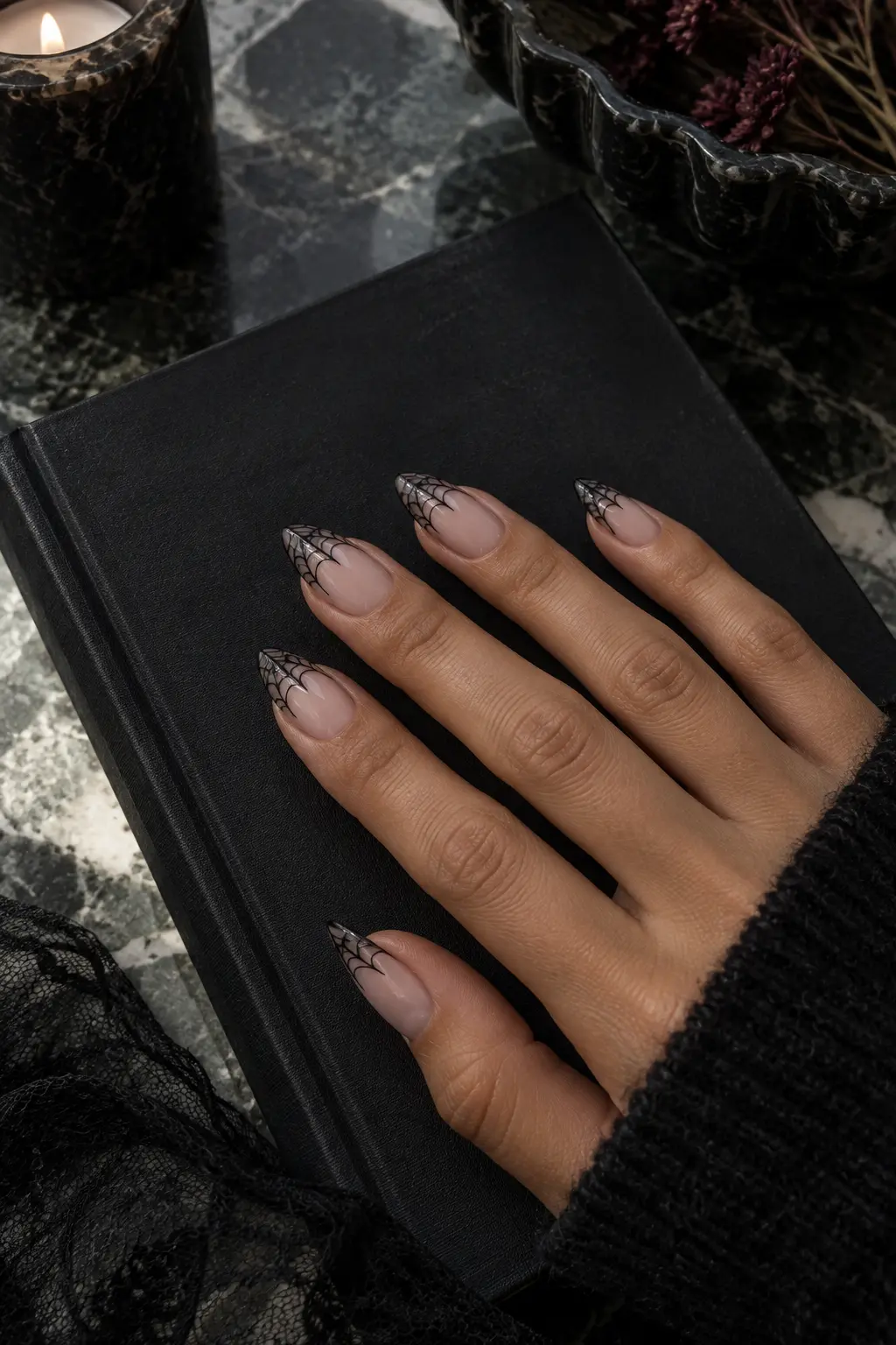 Sheer nude almond nails with fine black spiderweb French tips