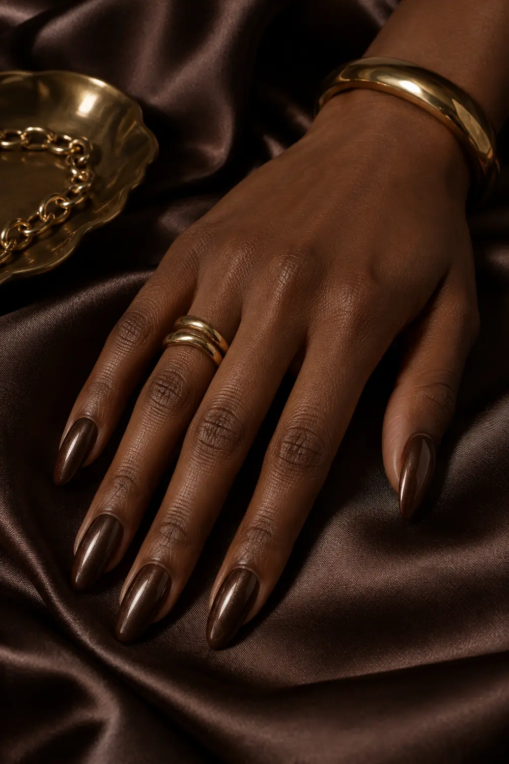 Chocolate brown chrome almond nails on dark satin