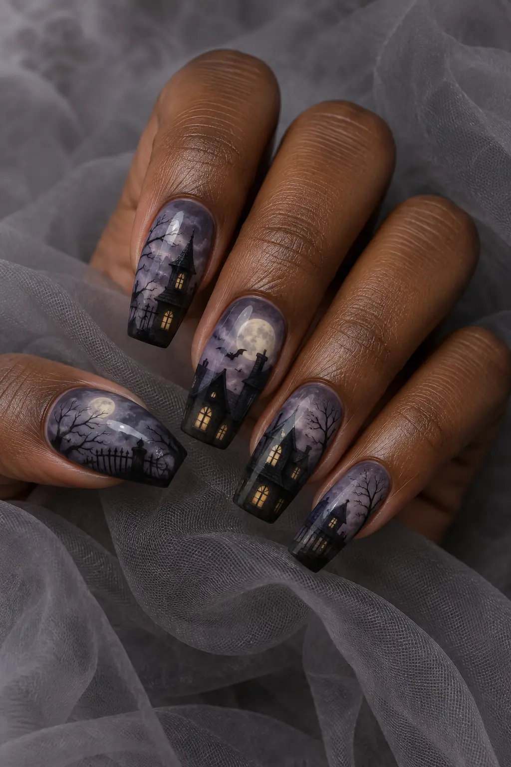 Smoky purple nails with black haunted house silhouettes and pale moons