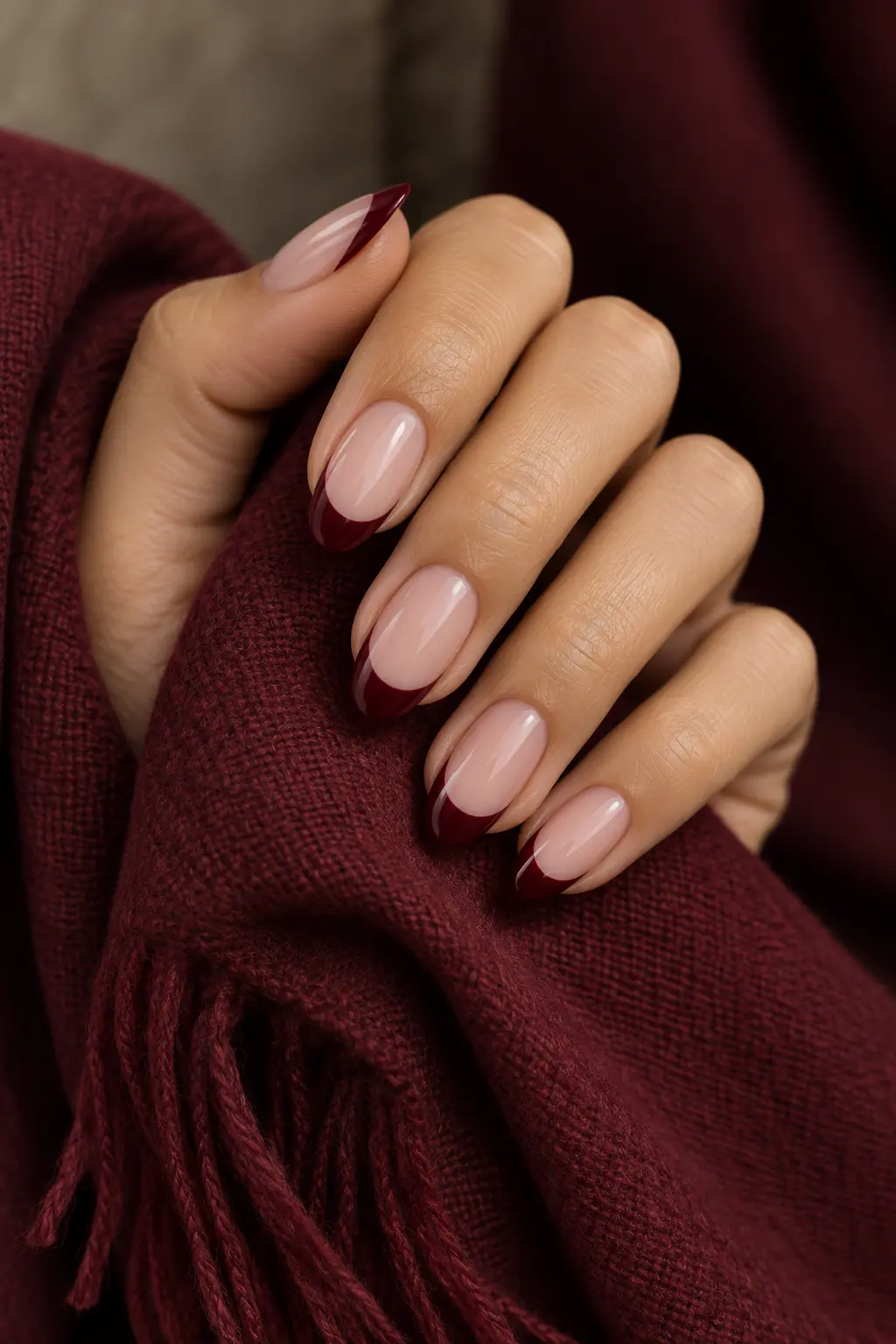 Sheer blush nails with deep burgundy French tips