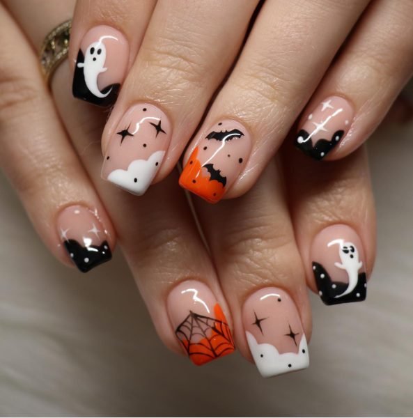 Square nude nails with black polka dot tips, white cloud tips, ghosts, bats and an orange spider web