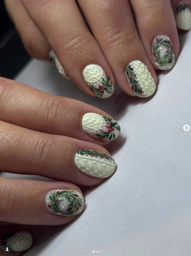 Short white matte nails with raised 3D cable knit texture and hand-painted green wreaths with red berries