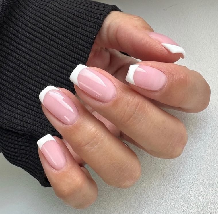 Medium square nails with a sheer pink base and crisp white French tips