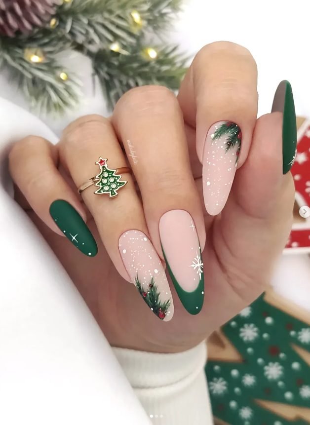 Long almond nails with matte emerald green, nude nails with snow dots and pine branches, and deep green V French tips