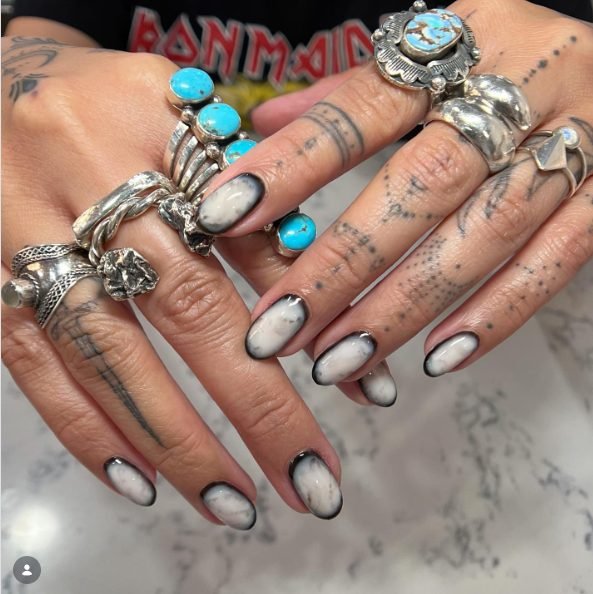Oval nails with a milky white center and a smoky black outline around each nail