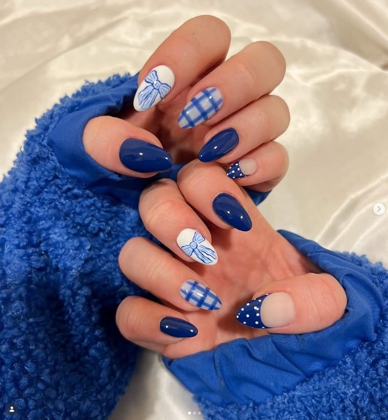Almond nails in navy blue with white bow nails, blue gingham nails and navy polka dot French tips