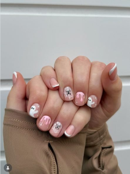 Short pink nails with white French tips, pink drips, white ghosts and spider webs