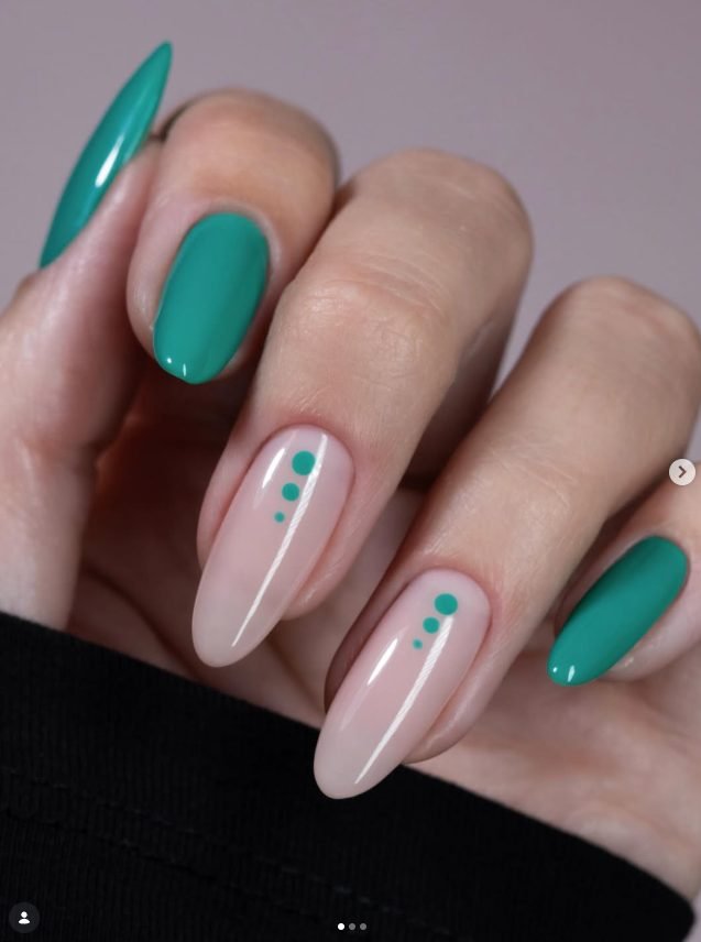 Long almond nails in glossy teal green with nude accent nails featuring three small teal dots