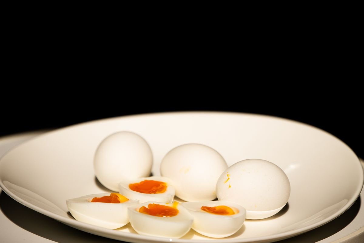 Plate of hard-boiled eggs, some sliced in half, a food source of biotin