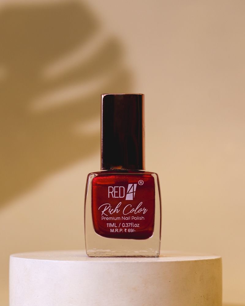 Elegant red nail polish bottle on minimalistic background, perfect for fashion and beauty themes.